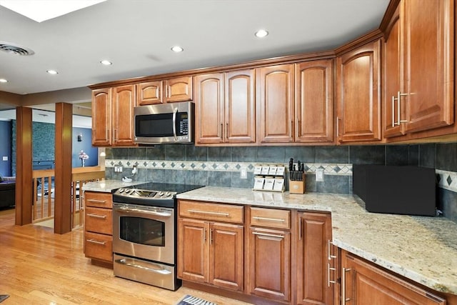 644 Stony Hill Rd, Wilbraham, MA 01095 - kitchen featuring appliances with stainless steel finishes, light stone countertops, light wood finished floors, decorative backsplash, and recessed lighting