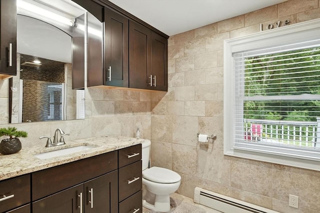 644 Stony Hill Rd, Wilbraham, MA 01095 - bathroom featuring tile walls, vanity, a baseboard heating unit, healthy amount of natural light, and a shower stall