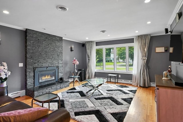 644 Stony Hill Rd, Wilbraham, MA 01095 - living area with crown molding, a baseboard heating unit, a fireplace, light wood-type flooring, and recessed lighting
