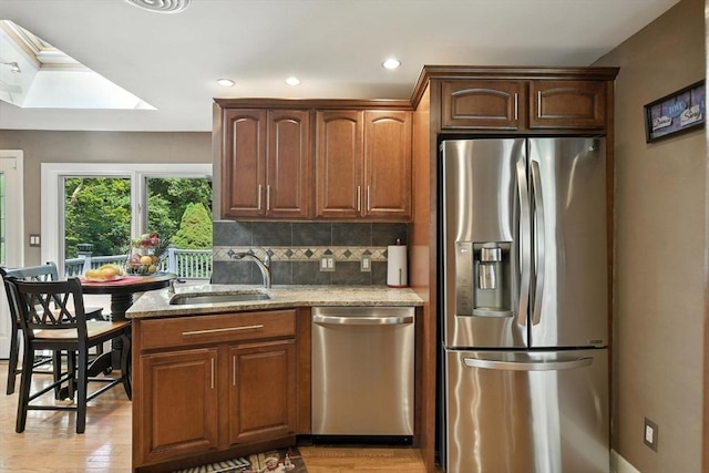 644 Stony Hill Rd, Wilbraham, MA 01095 - kitchen featuring stainless steel appliances, light stone counters, decorative backsplash, light wood-style floors, and recessed lighting