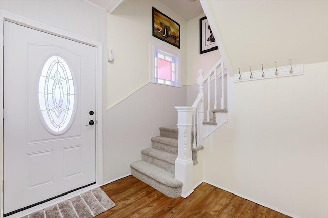 foyer entrance featuring stairs and wood finished floors