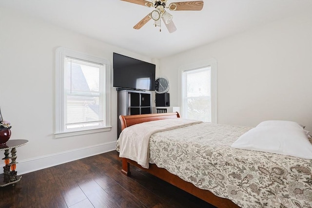 bedroom featuring wood finished floors, a ceiling fan, and baseboards