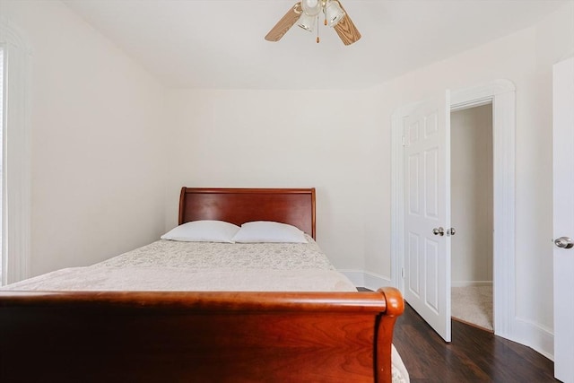 bedroom with ceiling fan, baseboards, and dark wood finished floors