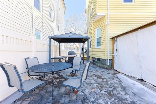 view of patio / terrace with outdoor dining area and a gazebo