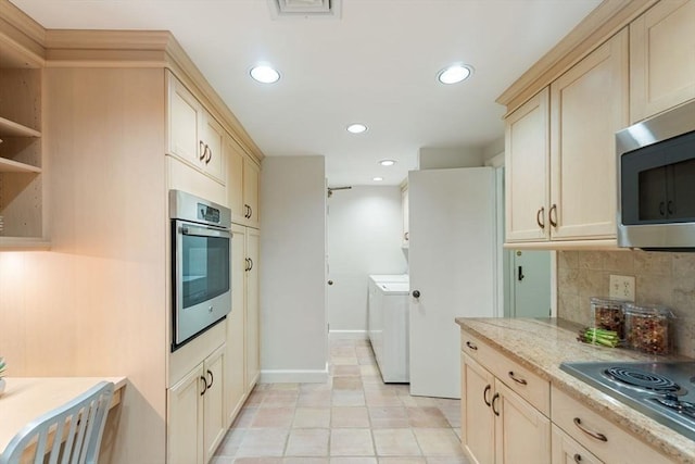 kitchen featuring decorative backsplash, washer / dryer, baseboards, recessed lighting, and stainless steel appliances