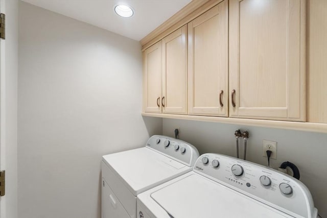 laundry room featuring recessed lighting, cabinet space, and washing machine and clothes dryer