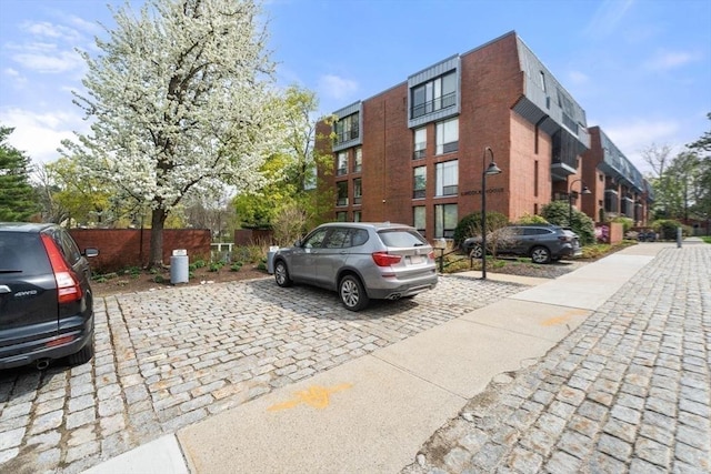 view of property featuring uncovered parking and fence