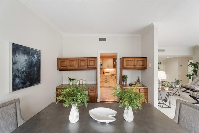 dining area with visible vents and ornamental molding