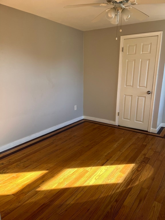 spare room with ceiling fan and hardwood / wood-style floors