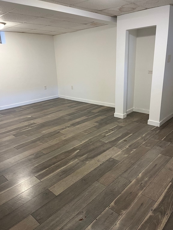 unfurnished room with dark wood-type flooring