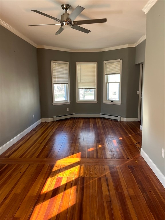 spare room with crown molding, dark hardwood / wood-style flooring, and ceiling fan