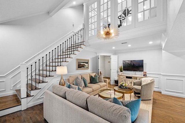 71 Weatherly Unit 71, Salem, MA 01970 - living room featuring a towering ceiling, stairs, wood finished floors, crown molding, and a decorative wall
