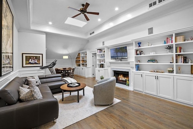 71 Weatherly Unit 71, Salem, MA 01970 - living area featuring ceiling fan, wood finished floors, ornamental molding, a raised ceiling, and a high end fireplace
