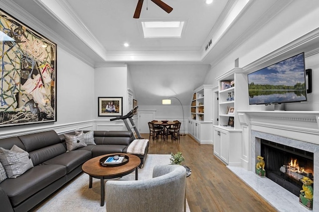71 Weatherly Unit 71, Salem, MA 01970 - living room featuring wood finished floors, a high end fireplace, ornamental molding, a raised ceiling, and built in shelves