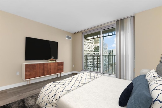 bedroom with dark wood-type flooring and access to exterior