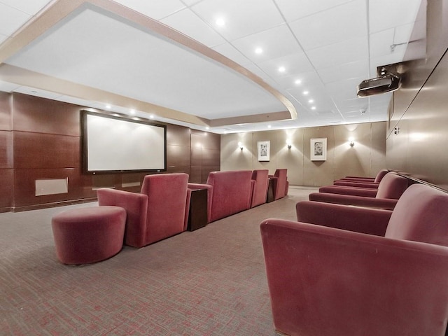 cinema featuring a tray ceiling, carpet floors, and a drop ceiling