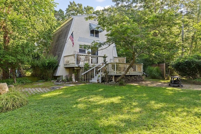 back of property featuring a yard and a wooden deck