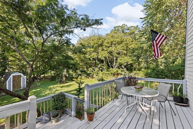 deck featuring a storage shed and a yard