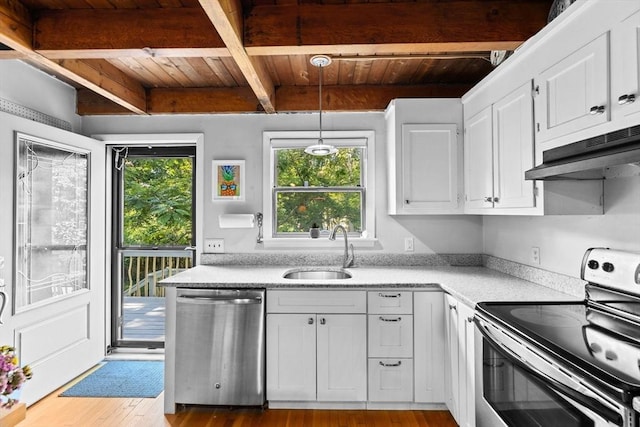 kitchen with pendant lighting, sink, beamed ceiling, white cabinetry, and stainless steel appliances