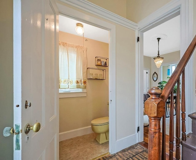 bathroom featuring toilet and baseboards