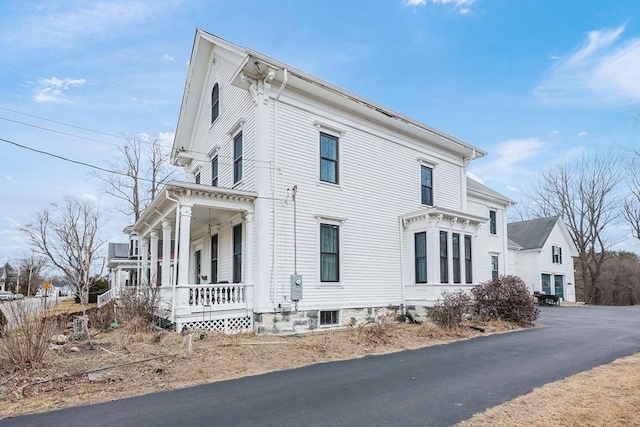 view of side of home with covered porch