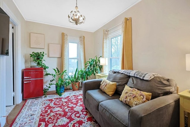 living area featuring a notable chandelier and crown molding