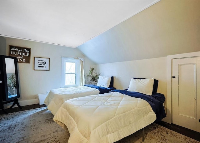 bedroom with baseboards and vaulted ceiling