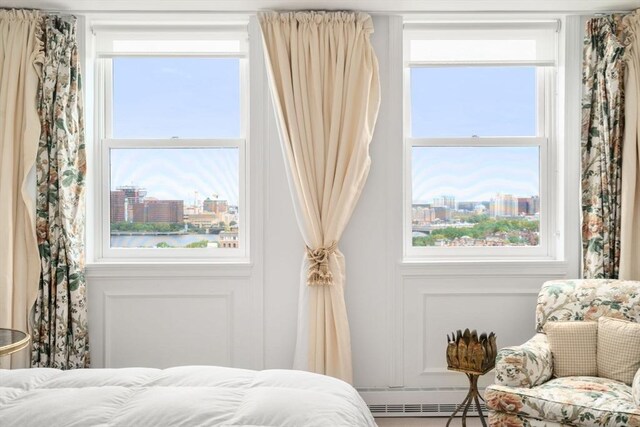 2 Commonwealth Ave Unit 15D, Boston, MA 02116 - bedroom with a view of city, multiple windows, and a baseboard radiator