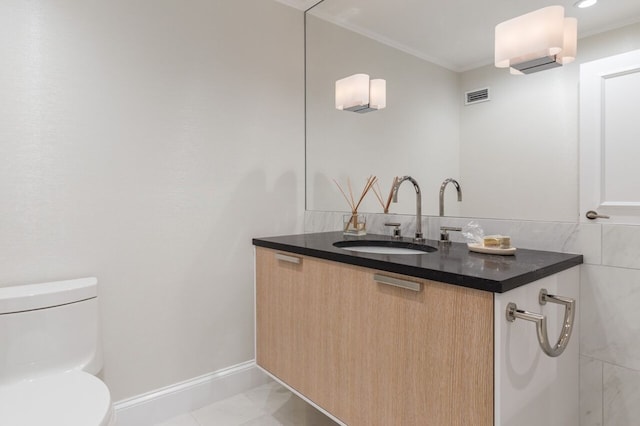 2 Commonwealth Ave Unit 15D, Boston, MA 02116 - bathroom featuring toilet, crown molding, vanity, and baseboards