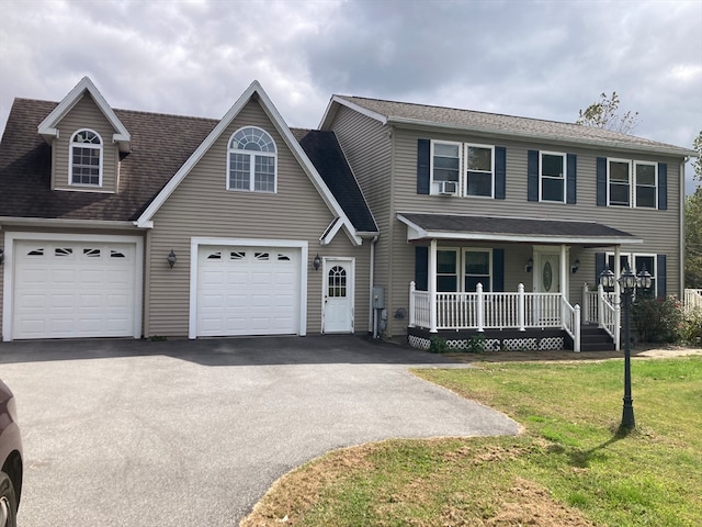 view of front facade featuring a garage, a front yard, and covered porch