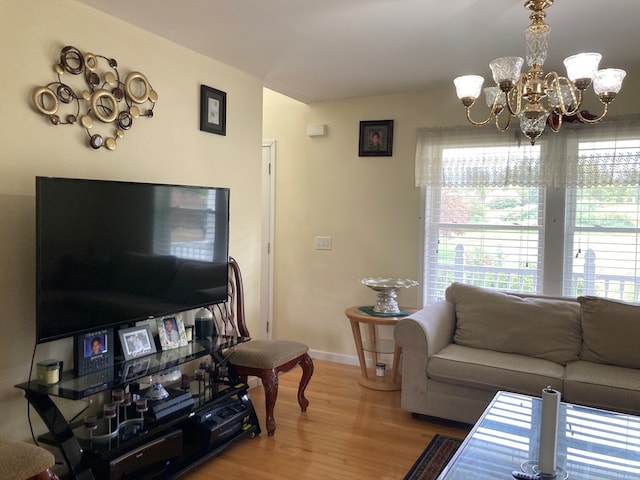 living room with wood-type flooring and a chandelier