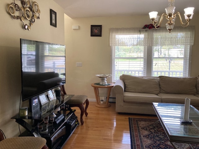 living room with hardwood / wood-style flooring and an inviting chandelier