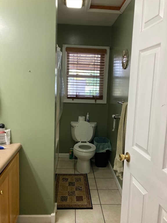 bathroom featuring toilet, vanity, and tile patterned flooring