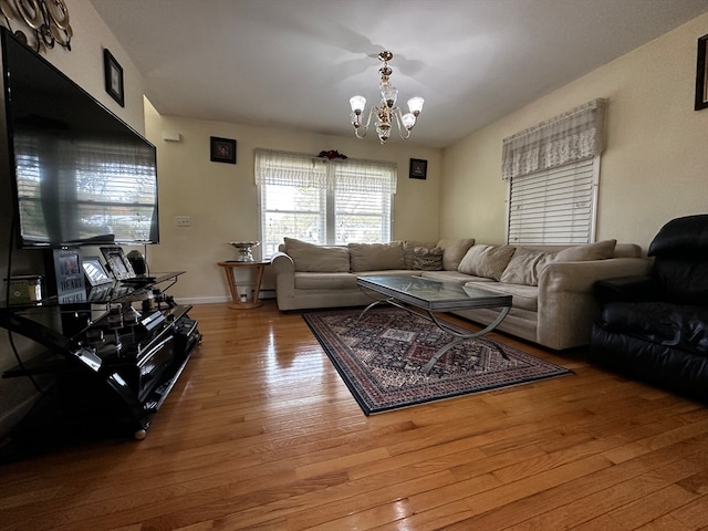 living room with hardwood / wood-style flooring and a chandelier