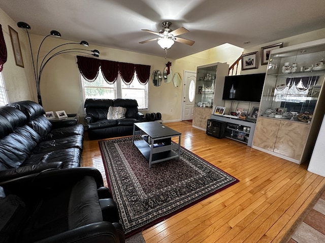 living room featuring hardwood / wood-style floors and ceiling fan