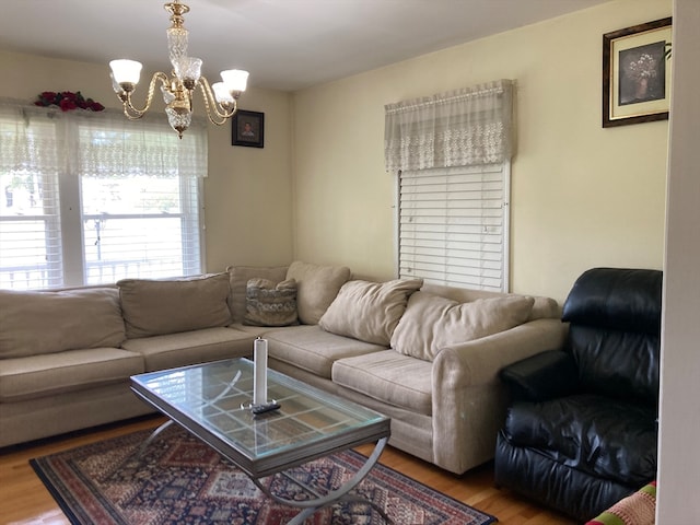 living room with hardwood / wood-style floors and a chandelier