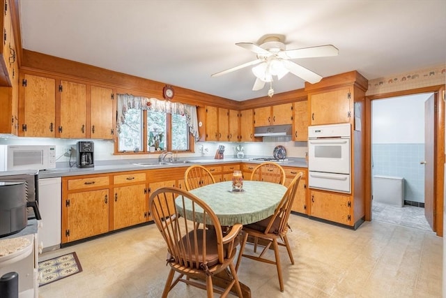 46 Pleasant St, Southbridge, MA 01550 - kitchen with white appliances, under cabinet range hood, a warming drawer, and light flooring