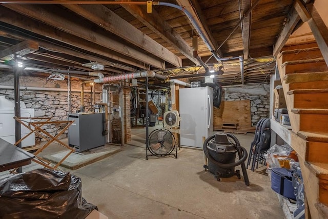 46 Pleasant St, Southbridge, MA 01550 - unfinished basement featuring washer / clothes dryer, freestanding refrigerator, and a heating unit