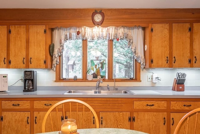 46 Pleasant St, Southbridge, MA 01550 - kitchen featuring light countertops, a sink, and brown cabinets