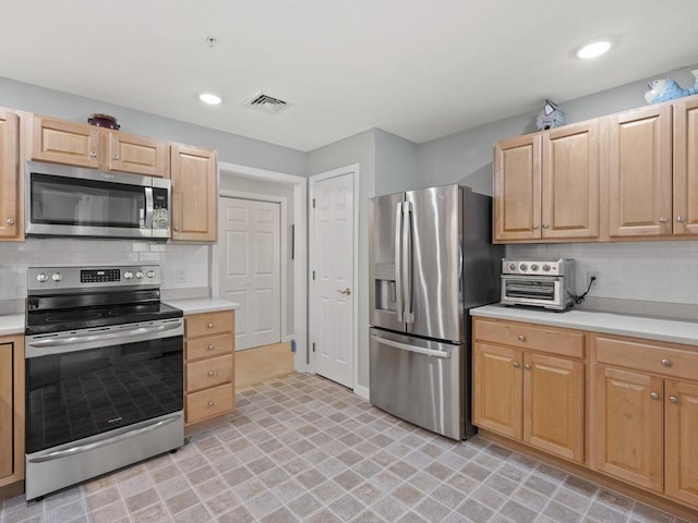 kitchen featuring tasteful backsplash, appliances with stainless steel finishes, and light brown cabinetry