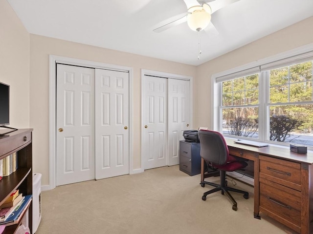 carpeted home office with ceiling fan