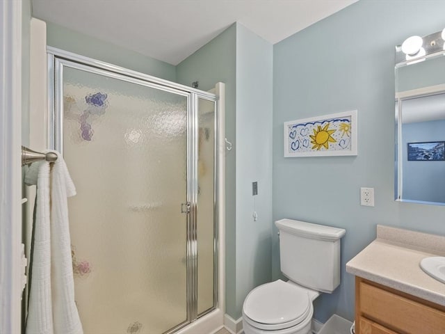 bathroom with walk in shower, vanity, and toilet