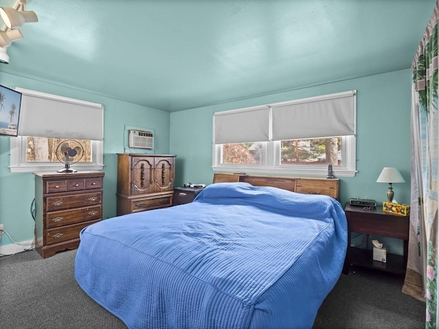 bedroom featuring an AC wall unit and carpet flooring