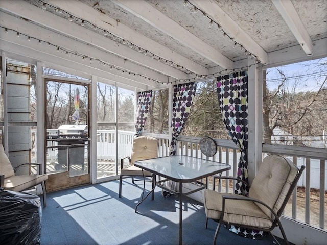 sunroom with beamed ceiling