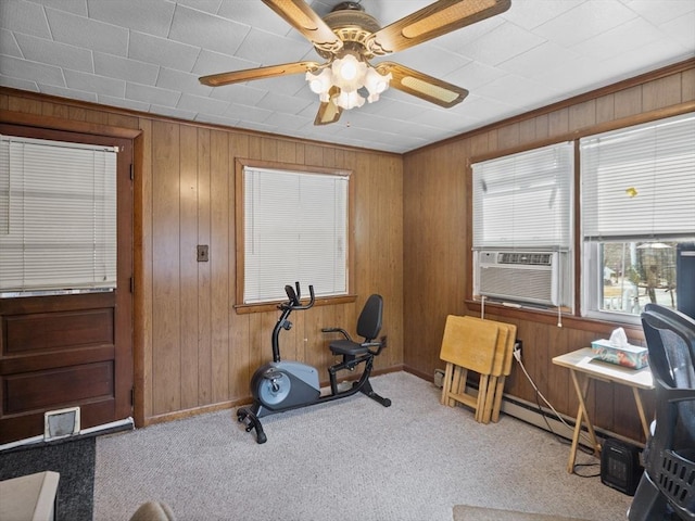 exercise room with cooling unit, carpet, visible vents, ceiling fan, and wood walls