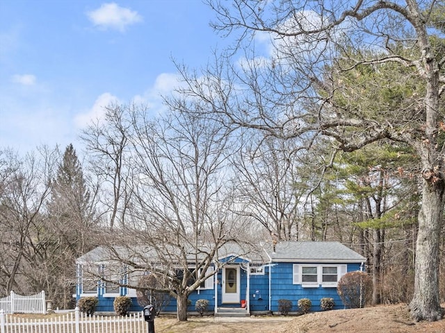 view of front of home with entry steps and fence