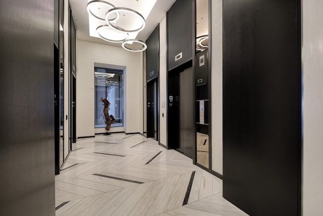 hall with light parquet flooring and elevator