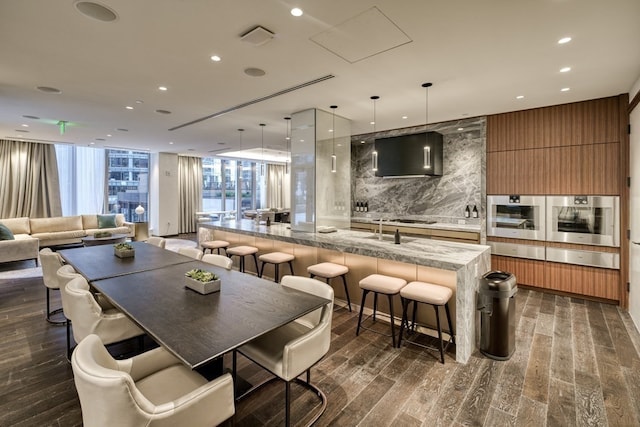 dining area with a wall of windows and dark wood-type flooring