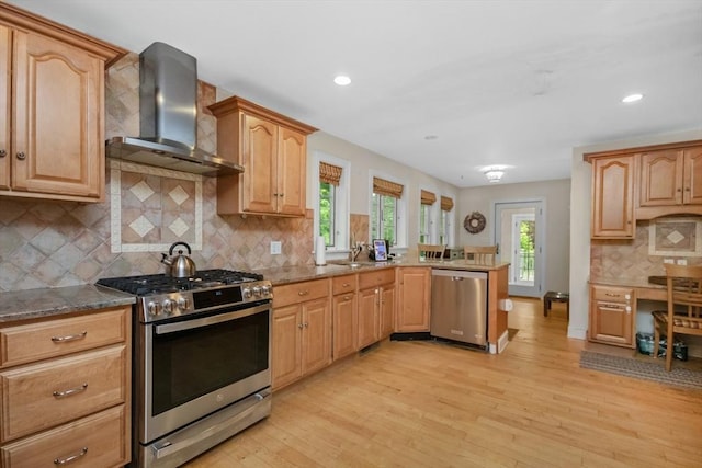 768 Plymouth St, Abington, MA 02351 - kitchen featuring stainless steel appliances, wall chimney range hood, light wood-type flooring, stone countertops, and tasteful backsplash