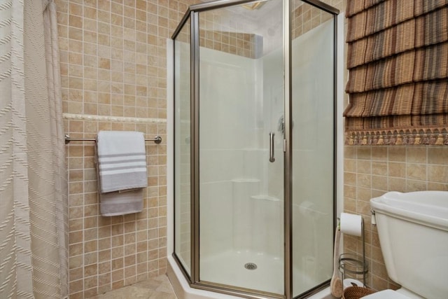 768 Plymouth St, Abington, MA 02351 - full bath featuring a stall shower, tile walls, toilet, and tile patterned floors